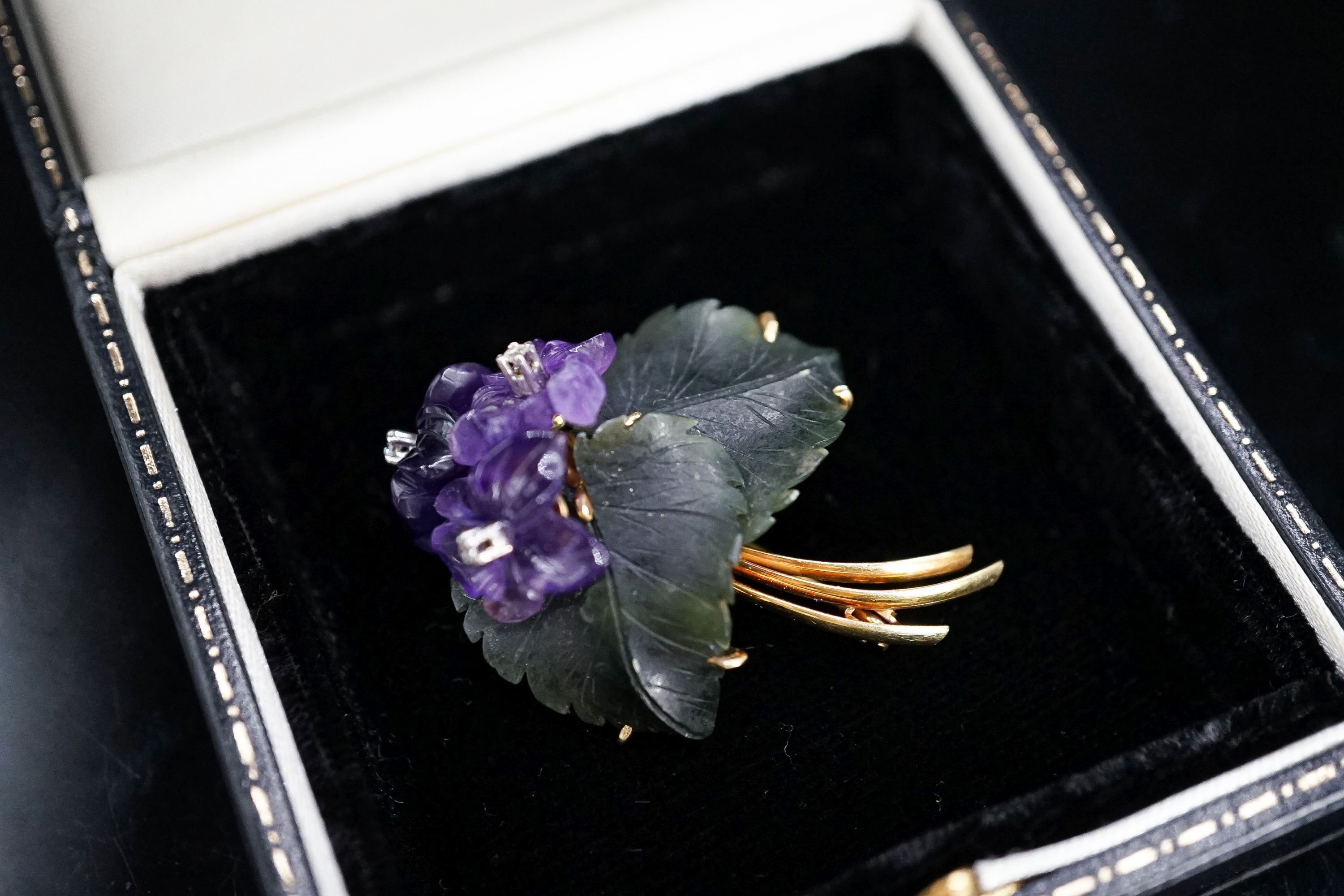 A continental Austrian? 585 yellow metal, diamond chip, carved nephrite and carved amethyst set flower head brooch, 39mm, gross 8.5 grams.